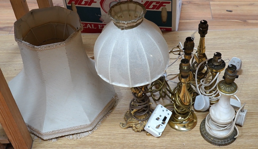 A figurative gilt metal table lamp, five brass table lamps and an alabaster lamp, tallest 35cm high. Condition - one poor, the others fair to good